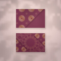 Burgundy business card template with Greek gold ornaments for your brand.