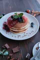 Plate of fresh pancakes with fruits