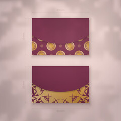 Burgundy business card template with Greek gold pattern for your contacts.