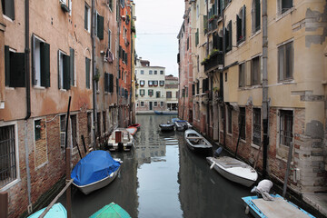 Typical view of a narrow canal between colorful historic buildings in Venice