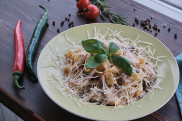 Mushrooms spaghetti pasta decorated with fresh basil