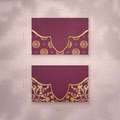 Burgundy business card template with Indian gold pattern for your business.