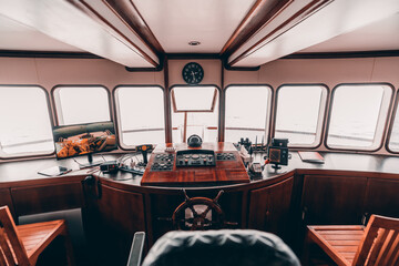 An orlop deck area inside of a deckhouse of a safari yacht or a boat with a control panel on the...