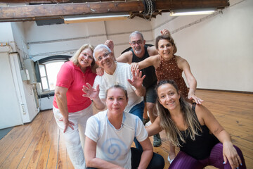 Happy senior dance group having fun after class in studio. Cheerful Caucasian pensioners laughing...