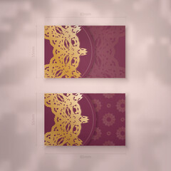 Burgundy business card template with vintage gold ornament for your contacts.