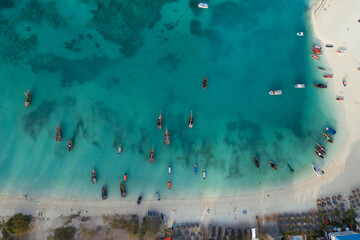 Tropical island of Zanzibar, Tanzania. Bay with fishing boats docked in azure water