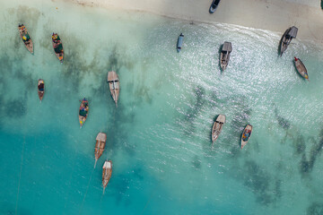 Tropical island of Zanzibar, Tanzania. Bay with fishing boats docked in azure water