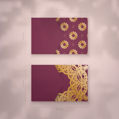 Burgundy business card template with vintage gold pattern for your brand.