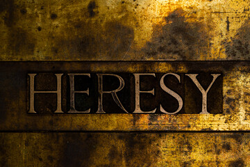 Heresy text message on textured grunge copper and vintage gold background