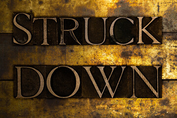 Struck Down text message on textured grunge copper and vintage gold background - obrazy, fototapety, plakaty