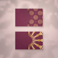 Burgundy business card with Greek gold ornaments for your personality.