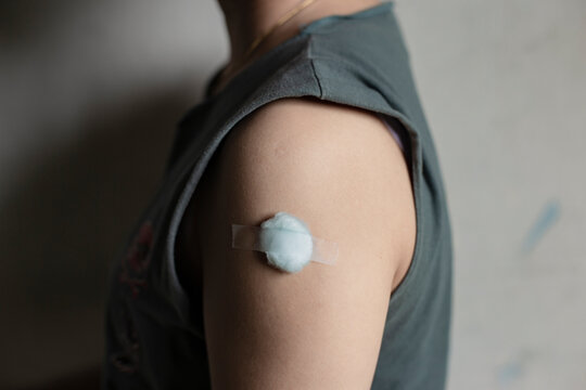 A Cotton Swab On Arm After Getting Vaccinated.