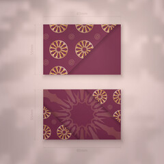 Burgundy business card with Indian gold pattern for your brand.