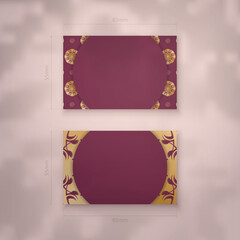 Burgundy business card with luxurious gold ornaments for your brand.