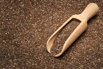 Organic natural chia seeds and wooden scoop close-up