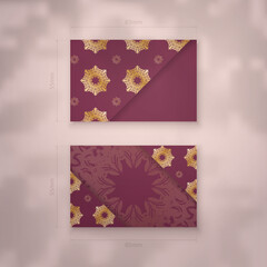 Burgundy business card with luxurious gold ornaments for your contacts.