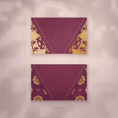Burgundy business card with luxurious gold pattern for your contacts.