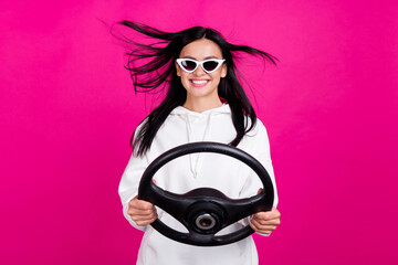 Photo of funny lady hold steering wheel driver license exam concept wear white sweatshirt isolated...