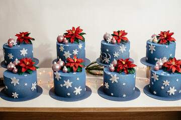 Showcase with cakes decorated in the New Year style. Festive Christmas cake decorated with spheres and snowflakes. Christmas dessert