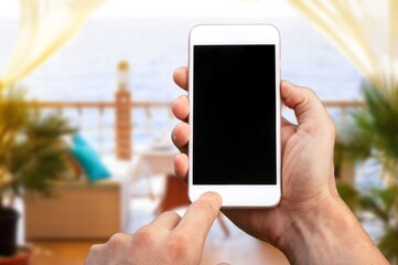 Hand hold a smartphone with a blank screen