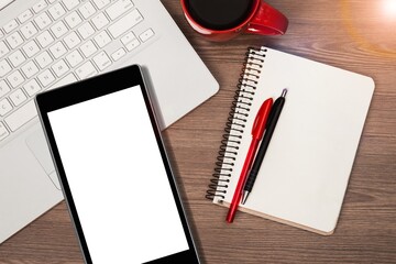 Modern smartphone with a blank screen and laptop