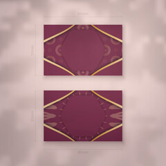 Business card in burgundy color with vintage gold pattern for your contacts.