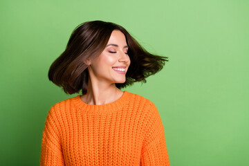 Obraz premium Portrait of attractive dreamy cheerful brunette girl throwing hair enjoying isolated over vivid green color background