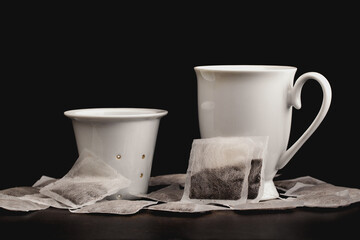 White ceramic tea mug and infuser with tea bags