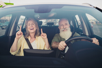 Photo of lovely senior married couple have fun listen music ride car vehicle together romantic trip outdoors