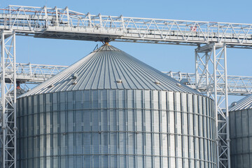 Metal elevator in an agricultural area. Large containers for storing crops of wheat or barley.