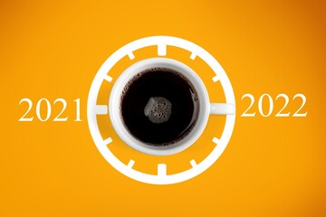 Happy new year 2022. Cup of coffee change 2021 to 2022 on the background. Start concept
