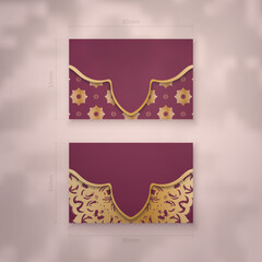 Business card template in burgundy color with Greek gold ornaments for your business.