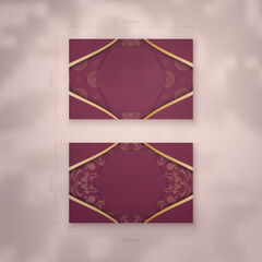 Business card template in burgundy color with greek gold pattern for your contacts.