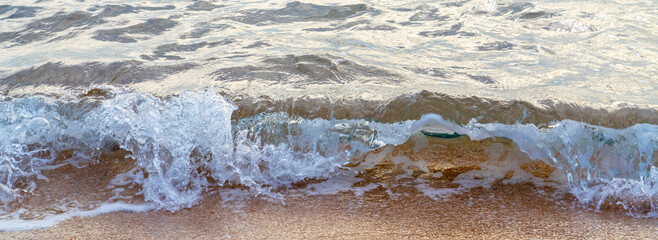 waves on the coastline of the beach in the evening with selective focus
