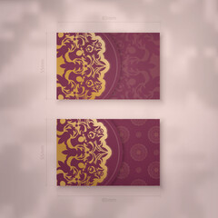 Business card template in burgundy color with luxurious gold pattern for your brand.