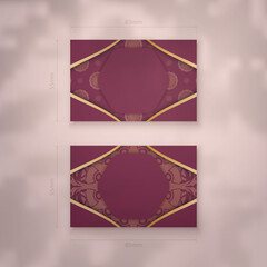 Business card template in burgundy color with mandala gold ornament for your business.