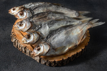 Ready-made silver bream fish, dried, dry, salted, appetizing laid out on a dark background. Catch...
