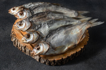 Ready-made silver bream fish, dried, dry, salted, appetizing laid out on a dark background. Catch river, fishing.