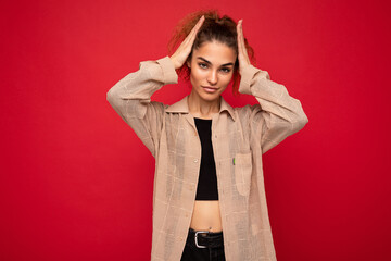 Shot of young attractive sexy stylish curly woman poising isolated on background wall with copy...