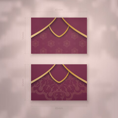 Business card template in burgundy color with vintage gold pattern for your business.