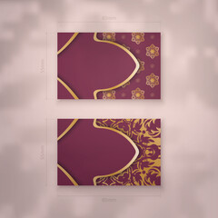 Business card template in burgundy color with vintage gold pattern for your contacts.