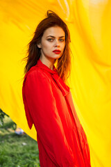 pretty woman in red dress nature yellow cloth on background