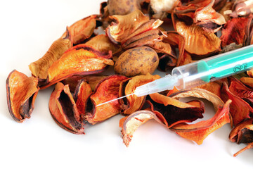 Preventative healtcare. Fall is time for flue shots. Syringe with autumn leaves on white...