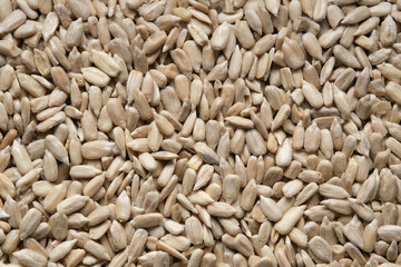 Shelled sunflower seeds background. Sunflower seed kernels texture. Top view, flat lay.
