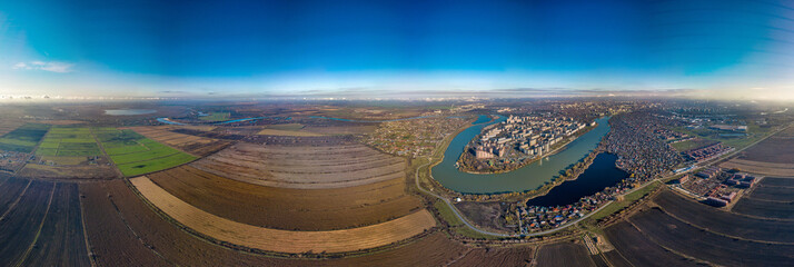 large aerial panorama - the western outskirts of the city of Krasnodar and the village of Starobrzhegokai (South of Russia), separated by the Kuban River - aerial panorama on a sunny autumn day - obrazy, fototapety, plakaty