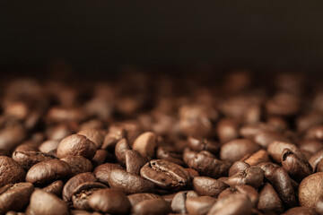 Heap of aromatic roasted coffee beans, closeup