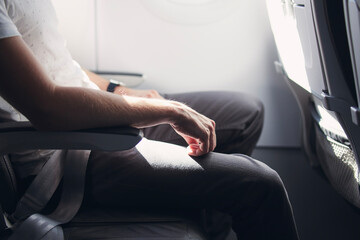 Man resting during flight. Legroom between seats in commercial airplane. .