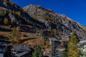 Fototapeta premium Spectacular alpine landscape, mountain Swiss wooden chalet with high mountains in background, Zermatt, Switzerland. October, 2021.