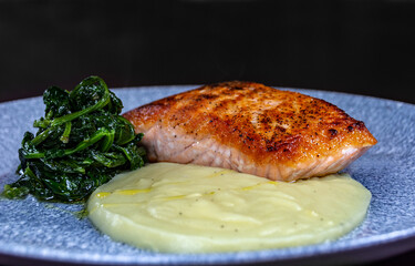 Salmon steak with mashed potatoes and broccoli