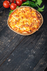 savory pie quiche lauren filling tomato, salmon, vegetables meal snack on the table copy space food background rustic. top view keto or paleo diet veggie vegan or vegetarian food no meat